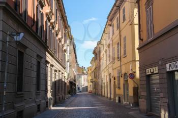 Piacenza, Italy - August 7, 2016: Narrow old street of historic city centre