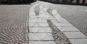 Ancient paving stones in historic centre of Piacenza, Italy