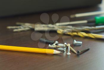 Pencil with metal screws engineering construction idea. Fix tool household. Home repair tools.