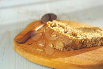 Bread slice organic natural food homemade wholegrain healthy nutrition. Rustical bread on wooden desk oldstyle eating. Tasty baker meal closeup. Selective focus crust piece. 
