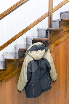 Royalty Free Photo of a Jacket Hanging on Stairs