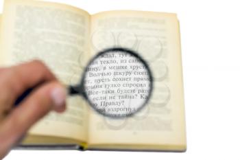 Royalty Free Photo of a Book Under a Magnifying Glass