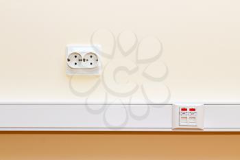 Royalty Free Photo of the RJ45 Socket and the Socket 220 on the Office Wall