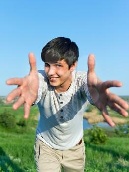 cheerful guy with outstretched arms outdoors