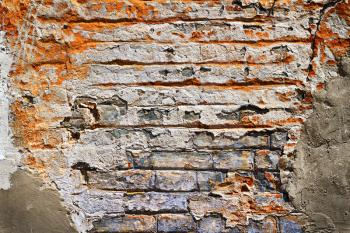 Grunge texture of old brick with plaster falls off in the background