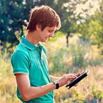 Royalty Free Photo of a Young Man Outside With a Tablet