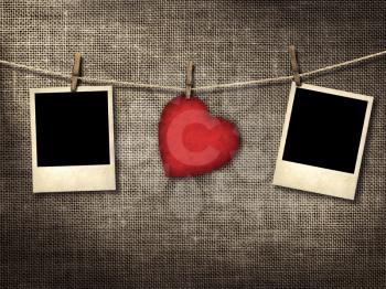 Old style photo and Valentine card heart shaped from old red paperr hanging on a clothesline on a linen background