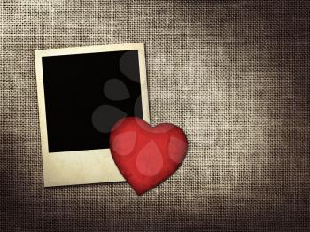 Polaroid-style photo and red paper heart on a linen background