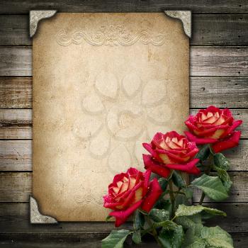 Old vintage frame for photos and a bouquet of red  roses