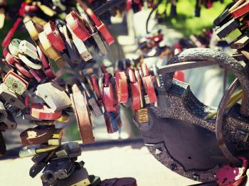 many different colored padlocks hung in a row