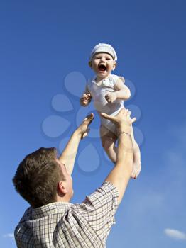 Father tossing baby in the air