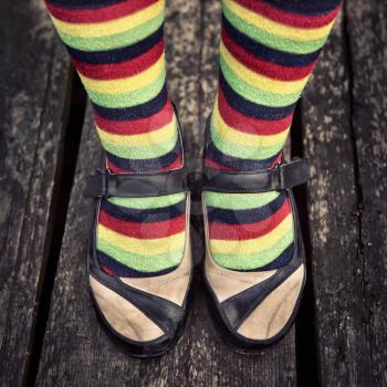 Female legs in striped socks in vintage style
