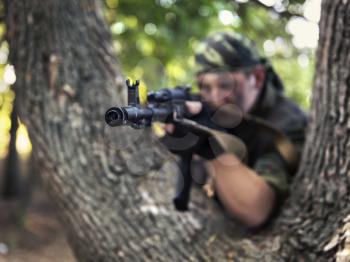 soldier shooting from a Kalashnikov closeup