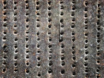 old rusty iron sheet with holes as a background
