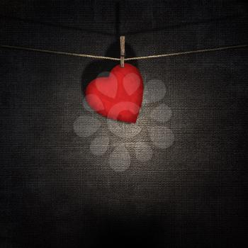 red paper heart on a rope over vintage embossed dark backgrounds