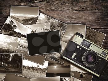 old vintage camera and photos on a wooden background