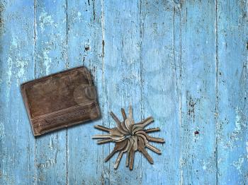 Purse and a bunch of keys on a blue wooden background