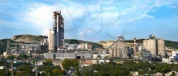 panorama of a cement plant in a sunny summer afternoon