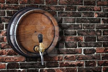 wooden barrel with a tap in the  old brick wall in grunge style