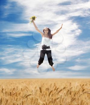 Beautiful Summer Landscape And Flying Young Woman With Bouquet Of Dandelions