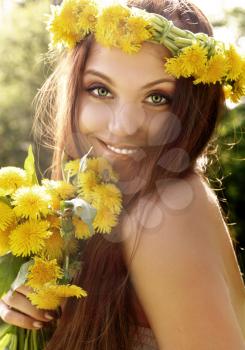 Attractive young summer girl with flowers