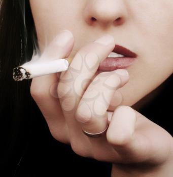 Color photo with the smoking young dark-haired woman 