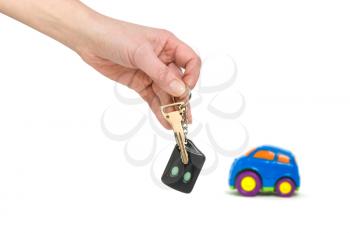 Royalty Free Photo of a Person Holding Keys Near a Toy Car