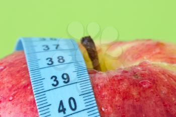 Royalty Free Photo of an Apple and Measuring Tape