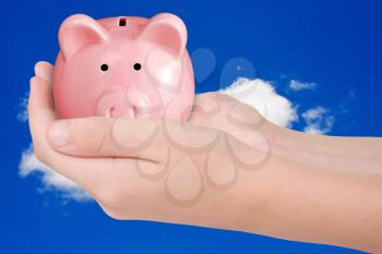 Royalty Free Photo of a Person Holding a Piggy Bank