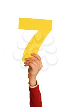 Royalty Free Photo of a Person Holding the Number Seven