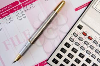 Royalty Free Photo of a Calculator on Payroll Documents