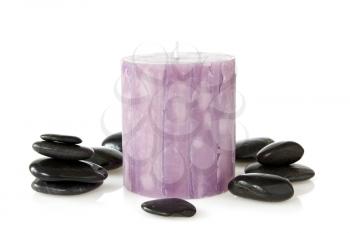 aromatic candle and black stones over a white background