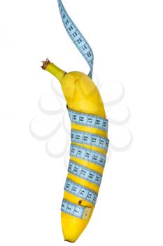 Banana hung on measure tape. Isolated over a white background