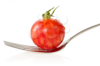 Cherry tomato on a fork. Isolated on white background
