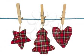 Handmade christmas decorations hang on the clothesline.Isolated on white background