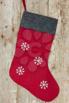 Red christmas sock hung on the old wooden wall