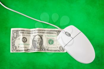 computer mouse placed on one dollar bill
