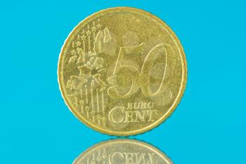 Fifty euro cent with reflection on blue background 
