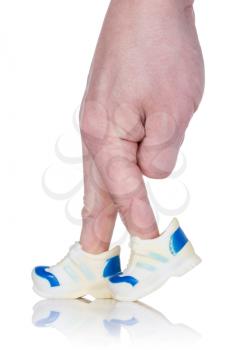 Fingers  wearing sports trainers and walking on white background