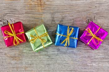 Four colorful gift boxes on the wooden floor