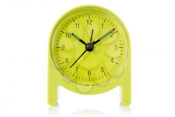 green alarm clock over a white background