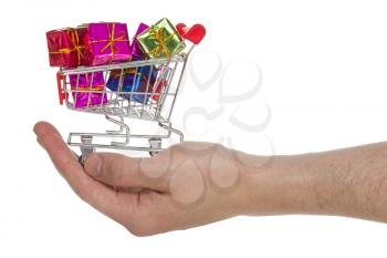 Hand with shopping cart full of gifts. Isolated on white background
