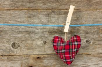 handmade heart hang  over a wooden background
