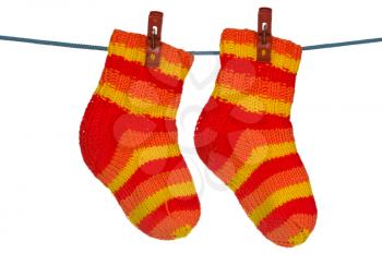 Knitted socks hung on the rope. Isolated over a white background