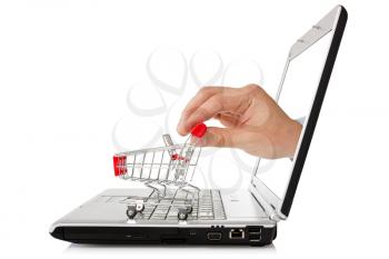 e-commerce concept. hand reaches out of a laptop with a shopping cart 