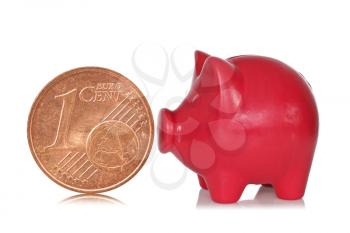 Red piggy bank and one eurocent on a white background