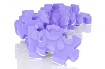 pile of purple puzzle on a white background
