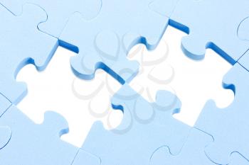 blue puzzle background with two missing pieces 