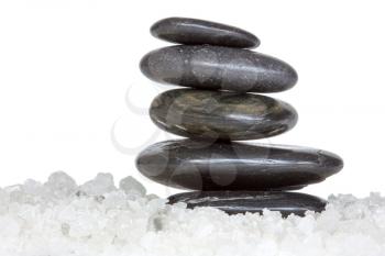 Spa stones in a sea salt, isolated over a white background