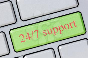 Keyboard with green 24/7 support button, business concept